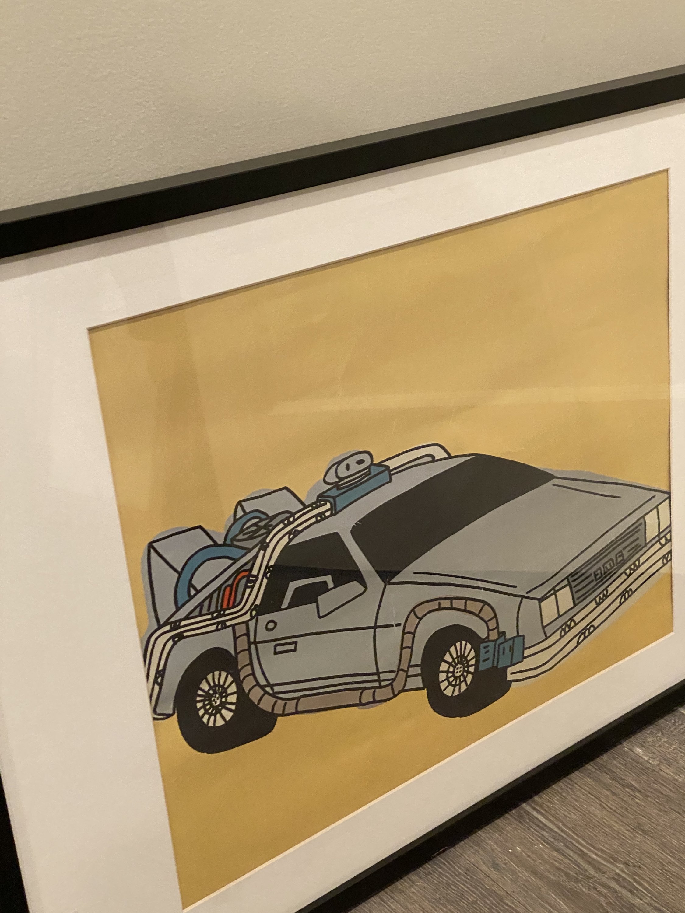 Rare Marz Jr. signed pop art of DMC DeLorean, framed and colorful, showcasing nostalgic design.